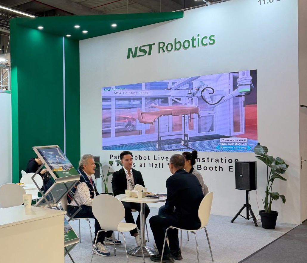 The NST Robotics stand at Automechanika Frankfurt 2026, Hall 11.0 Booth D37, with a painting demonstration on the display wall