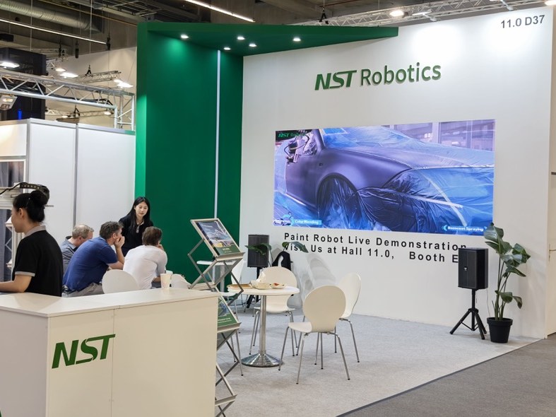 Visitors talking with NST staff at the NST Robotics stand, Hall 11.0 Booth D37