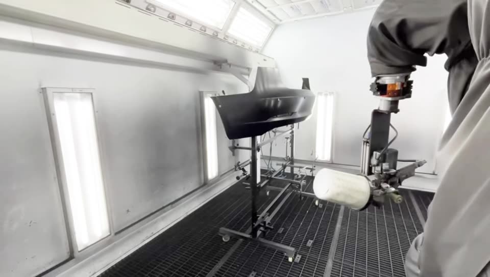 The NST robot spraying several car parts in one run